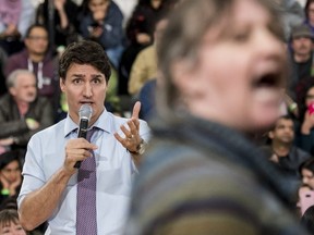Prime Minister Justin Trudeau speaks with a protestor during a town hall meeting in Cambridge, Ont., on Tuesday April 16, 2019.