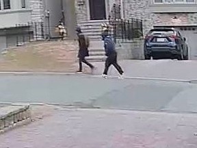 Toronto Police released security video which includes this image of two suspected burglars.