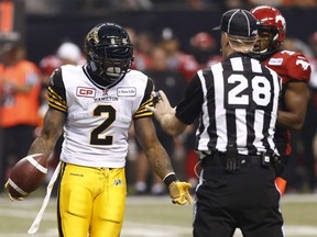 Nic Grigsby of the Tiger-Cats speaks to a referee during the 102nd Grey Cup at B.C. Place in Vancouver, B.C., on Nov. 30, 2014.