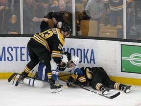 Boston Bruins defenceman Zdeno Chara (left) pulls Maple Leafs centre Nazem Kadri off teammate Jake DeBrusk during the third period of Game 2 on Saturday night in Boston. (Mary Schwalm/The Associated Press)