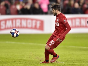 Toronto FC’s Alejandro Pozuelo chips over the keeper to score on a penalty shot against New York City FC last Friday in Toronto. Pozuelo scored twice and added an assist in his Reds debut. (CP FILES)