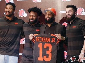 Browns' Odell Beckham poses with his jersey along with Baker Mayfield, right, Myles Garrett, left, and Jarvis Landry during a news conference Monday, April 1, 2019, in Berea, Ohio.