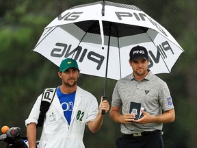 Corey Conners of Canada waits with caddie Kyle Peters on the 18th green during the final round of the Masters April 14, 2019 in Augusta, Georgia. (Mike Ehrmann/Getty Images)
