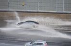 A car drives through a flooded portion of the westbound 401 near Avenue Rd. on April 26, 2019. Heavy rain caused localizing ponding and flooding throughout the Toronto area