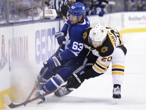 Maple Leafs’ Tyler Ennis (left) is nudged against the boards by Boston Bruins’ Joakim Nordstrom during Game 4 on Wednesday night. (THE CANADIAN PRESS)