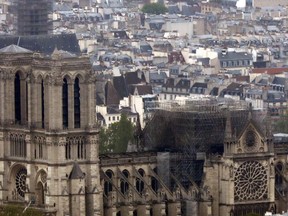 Notre Dame cathedral is pictured from the top of the Montparnasse tower, Tuesday April 16, 2019 in Paris. Firefighters declared success Tuesday morning in an over 12-hour battle to extinguish an inferno engulfing Paris' iconic Notre Dame cathedral that claimed its spire and roof, but spared its bell towers. (AP Photo/Thibault Camus)