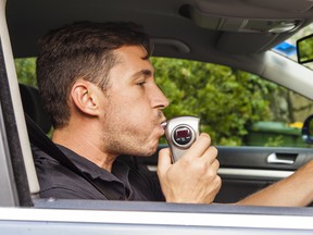 Man blowing into breathalyzer.