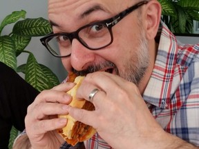 John Catucci testing one of the veal sandwiches from last year's Best Veal Sandwich competition. This year promises to be even an more tastier event. - Photo by Rita DeMontis