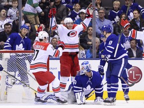 Carolina Hurricanes defenceman Dougie Hamilton (centre) celebrates his second-period goal against Maple Leafs goaltender Garret Sparks on Tuesday night at Scotiabank Arena. Hamilton would add another into an empty net in the dying seconds of the game. (Frank Gunn/The Canadian Press)