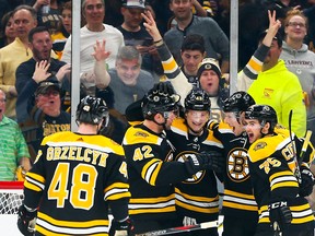 Bruins players celebrate Danton Heinen's goal in the second period of Game 2 against the Maple Leafs on Saturday night. (Adam Glanzman/Getty Images)