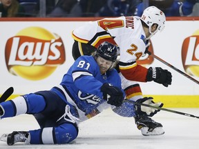 Winnipeg Jets' Kyle Connor and Calgary Flames' Travis Hamonic could be seeing more of each other if the two teams meet in the West final. THE CANADIAN PRESS/John Woods