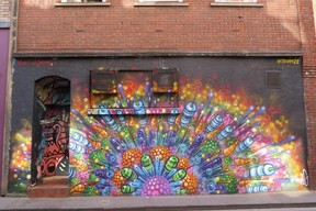 Dozens of colourful rockets in an abstract street art painted on the side of a building on Frogmore St. in Bristol by an artist who signed as 3DOM22. (Ian Robertson)
