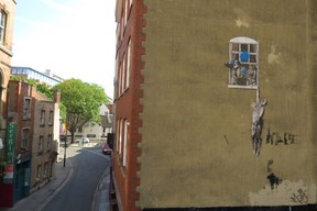 Banksy’s ‘The Well Hung Lover’ on the side of the former Brook Sexual Health Clinic on Frogmore St. beside the Park Street Bridge. (Ian Robertson)
