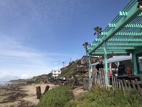 The atmospheric Beachcombers Cafe, in a converted 1950s cottage, has an outdoor dining patio under a striped awning and is a popular spot for casual dining on the oceanfront.