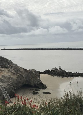 The Wedge, seen in the distance of this photograph of Newport Harbour, is a man-made barrier that separates the Pacific Ocean from Newport Harbour.