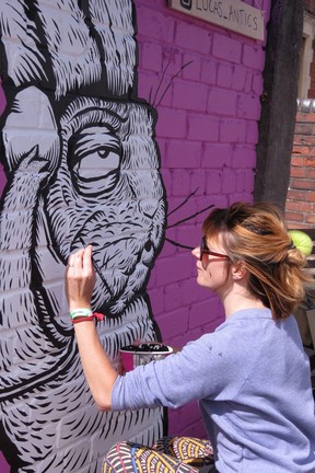 Bristol artist ‘Lucas Antics’ finishes a large rabbit on the telephone, influenced by ‘Alice in Wonderland.’ (Ian Robertson)