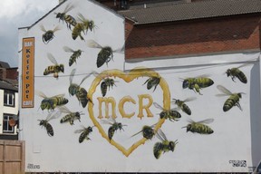 The outside wall of Koffee Pot Cafe Bar, 84-86 Oldham St., with 22 large worker bees in honour of the 22 people killed in 2017 outside Manchester Arena by a suicide bomber, was painted that spring by graffiti artist Russell Meeham, also know as ‘Qubek.’ (Ian Robertson)