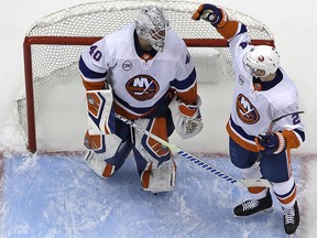 New York Islanders goaltender Robin Lehner, left, celebrates with Scott Mayfield (24) after a win over the Pittsburgh Penguins in Game 3, Sunday, April 14, 2019. (AP Photo/Gene J. Puskar)