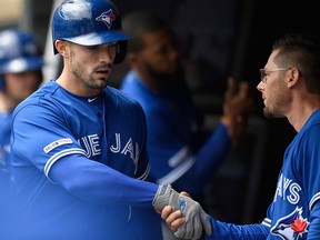 Eric Sogard of the Toronto Blue Jays congratulates teammate Randal Grichuk on a solo home run against the Minnesota Twins on April 18, 2019 at Target Field in Minneapolis. (Hannah Foslien/Getty Images)