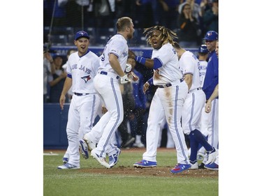 Toronto Blue Jays Brandon Drury 3B (3) is congratulated by Toronto Blue Jays Vlad Guerrero Jr. 3B (27) after hitting a two-run homer In the ninth inning in Toronto, Ont. on Friday April 26, 2019. Jack Boland/Toronto Sun/Postmedia Network