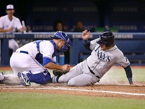 Avisail Garcia of the Tampa Bay Rays is tagged out at home plate by Luke Maile of the Toronto Blue Jays as he tries to score during MLB action at Rogers Centre on April 13, 2019 in Toronto. (Tom Szczerbowski/Getty Images)
