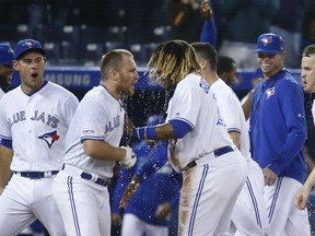Blue Jays Brandon Drury 3B  is congratulated by Blue Jays Vlad Guerrero Jr. after hitting a two-run homer In the ninth inning on Friday night. (Jack Boland/Toronto Sun/Postmedia Network)