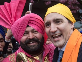 Prime Minister Justin Trudeau, right, poses for a photograph with Gurmukh Singh after marching in the Vaisakhi parade, in Vancouver on Saturday, April 13, 2019.