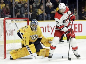 Nashville Predators goaltender Juuse Saros (74) guards the net as Carolina Hurricanes right wing Justin Williams reaches for the puck Saturday, March 9, 2019, in Nashville, Tenn. (AP Photo/Mark Humphrey)