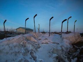 Hockey sticks were placed in a snowbank on April 12, 2018 as a memorial to the Humboldt Broncos following the team's bus crash in which 16 people were killed and 13 more were injured.