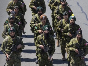 Members of the Canadian Armed Forces make their way along Lake Shore Blvd W. as a part of the 41st Annual Sikh Khalsa Day Celebration on Sunday.