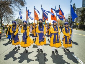 The Five Beloveds walk ahead of the Holy Guru Granth Sahib (a holy book) along Lake Shore Blvd W. during the 41st Annual Sikh Khalsa Day Celebration in Toronto, Ont. on Sunday April 28, 2019.