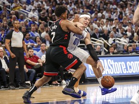 Orlando's Aaron Gordon is guarded by the Raptors' Kyle Lowry  during Game 3 of their opening-round playoff series.  (Don Juan Moore/Getty Images)