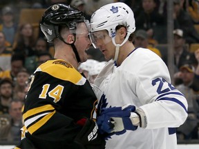 Boston Bruins right wing Chris Wagner (14) and Toronto Maple Leafs defenseman Nikita Zaitsev (22) go head-to-head during Game 2 of their first-round playoff series, Saturday, April 13, 2019, in Boston. (AP Photo/Mary Schwalm)