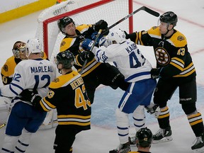 Boston Bruins defenceman Connor Clifton and Toronto Maple Leafs centre Nazem Kadri shove each other at the goal during the third period of Game 2 of an NHL first-round playoff series, Saturday, April 13, 2019, in Boston.