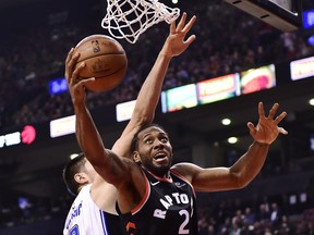Raptors forward Kawhi Leonard (2) is fouled by Orlando Magic centre Nikola Vucevic as he goes to the hoop on Monday night at Scotiabank Arena. (Frank Gunn/The Canadian Press)