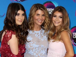 Full House star Lori Loughlin and her daughters  Bella, left, and Olivia Jade at the Teen Choice Awards in Los Angeles on Aug. 13, 2017.