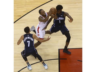 Toronto Raptors Kawhi Leonard SF (2) is double teamed by Orlando Magic Jonathan Isaac PF (1) and teammate  Michael Carter-Williams PG (7) during the fourth quarter  in Toronto, Ont. on Wednesday April 17, 2019. Jack Boland/Toronto Sun/Postmedia Network
