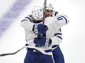 Maple Leafs center John Tavares, rear, is embraced by left wing Zach Hyman (11) after his empty-net goal against the Boston Bruins on Thursday night.  The Leafs won 4-1. (AP Photo/Charles Krupa)
