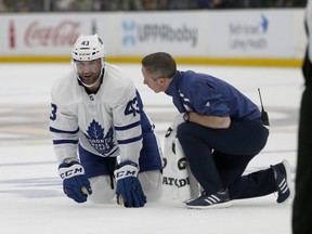 Toronto Maple Leafs center Nazem Kadri (43) looks up from the ice as he is attended to by a trainer after taking a hit during the second period of Game 2 of an NHL hockey first-round playoff series against the Boston Bruins, Saturday, April 13, 2019, in Boston. (AP Photo/Mary Schwalm)