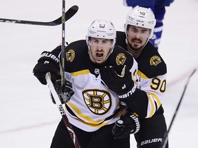 Boston Bruins forward Brad Marchand (left) noted the Leafs’ recent success at TD Garden. He’s not fond of the ice there either, adding “we might as well play with a tennis ball, skate around and see who can bounce one in the net.” (The Canadian Press)