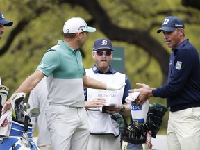 Sergio Garcia, second from left and Matt Kuchar, right, discuss on the eighth hole what had happened on the seventh green, during the Dell Technologies Match Play Championship golf tournament, Saturday, March 30, 2019, in Austin, Texas. Garcia had an 8-foot putt to win the seventh hole and left it 4 inches short, a frustrating miss. Worse yet was what followed. Such a tap-in typically is conceded in the Dell Technologies Match Play, and the Spaniard walked up and casually rapped it left-handed. The ball spun around the cup, and he picked it up and walked off the green, assuming he remained 1 down through seven holes. One problem: Matt Kuchar never formally conceded the putt.