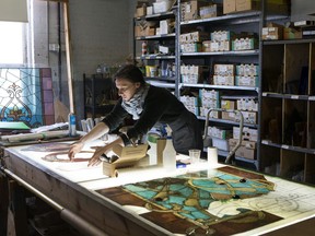 Elise Guerra creates a new layer of a stained glass picture that depicts the composer Charles Gounod, during restoration work on Massey Hall's 125-year-old stained glass windows at Toronto's EGD Glass & Vitreous Glassworks on Thursday, April 4, 2019.