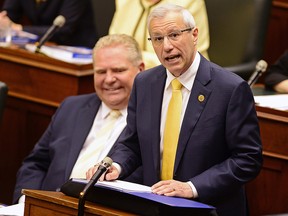 Ontario Finance Minister Vic Fedeli presents the 2019 budget as Premier Doug Ford looks on at the legislature in Toronto on Thursday. (THE CANADIAN PRESS/Frank Gunn)