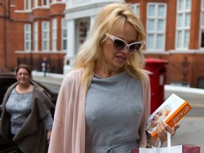 Pamela Anderson delivers lunch to her "friend" Wikileaks founder Julian Assange.