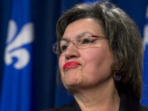 Fatima Houda-Pepin meets reporters after presenting her bill to modify the Quebec Charter of Values to the three parties at the legislature, February 18, 2014 in Quebec City. THE CANADIAN PRESS/Jacques Boissinot