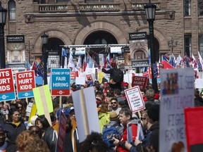 Thousands of union members swarm the front lawn of Queen's Park to protest education reforms on Saturday, April 6 2019.
