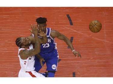 Toronto Raptors Kawhi Leonard SF (2) is fouled by Philadelphia 76ers Jimmy Butler SG (23) during the first half in Toronto, Ont. on Sunday April 28, 2019. Jack Boland/Toronto Sun/Postmedia Network