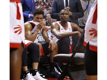 Toronto Raptors Kyle Lowry PG (7) and teammate Serge Ibaka on the bench during a time out during the first half in Toronto, Ont. on Tuesday April 23, 2019. Jack Boland/Toronto Sun/Postmedia Network
