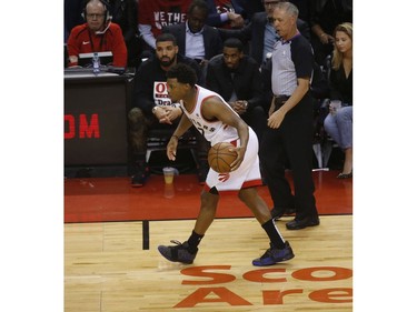 Toronto Raptors Kyle Lowry PG (7) brings the ball up the court past Drake during the first half in Toronto, Ont. on Tuesday April 23, 2019. Jack Boland/Toronto Sun/Postmedia Network