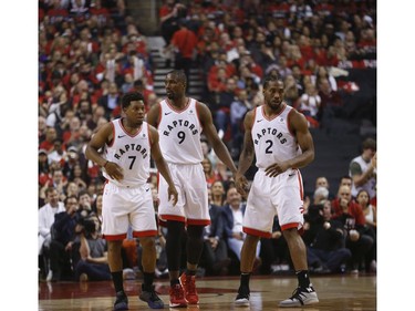 Toronto Raptors Kawhi Leonard SF (2) with teammates TKyle Lowry PG (7) and Serge Ibaka C (9) during the first half in Toronto, Ont. on Tuesday April 23, 2019. Jack Boland/Toronto Sun/Postmedia Network